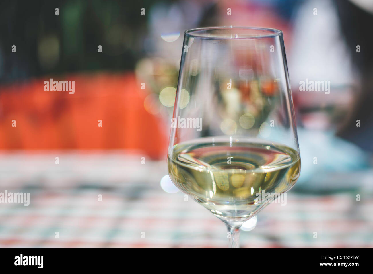 a glass of white wine on the table Stock Photo