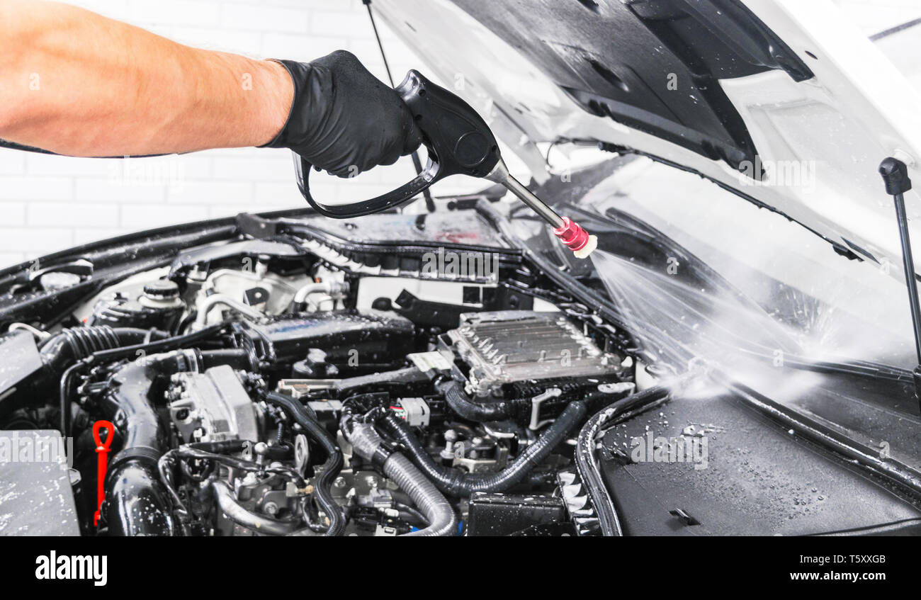 Car detailing. Manual car wash engine with pressure water. Washing car