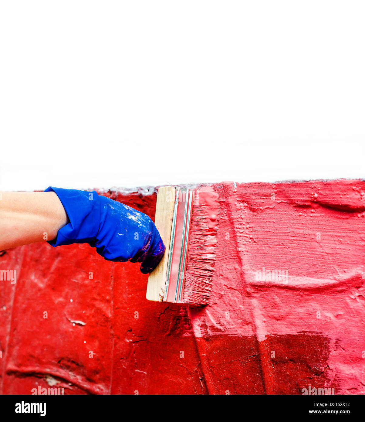 Paint the wall in red with a large wide paint brush Stock Photo Alamy