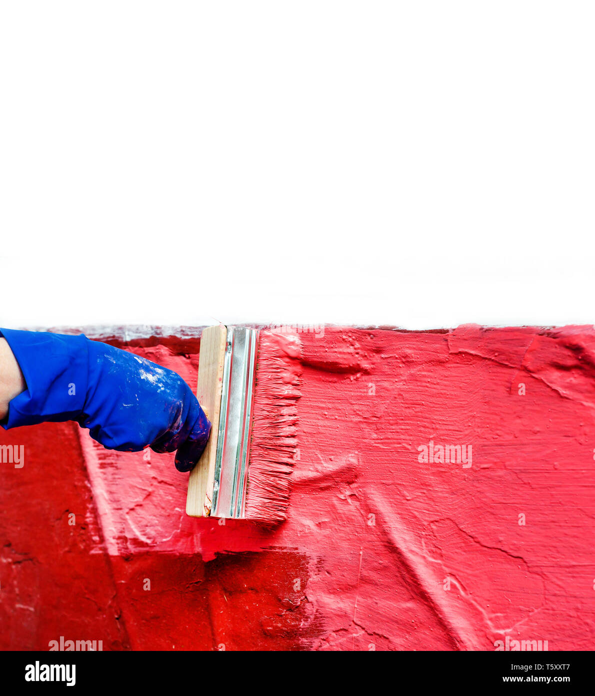 Paint the wall in red with a large wide paint brush Stock Photo Alamy