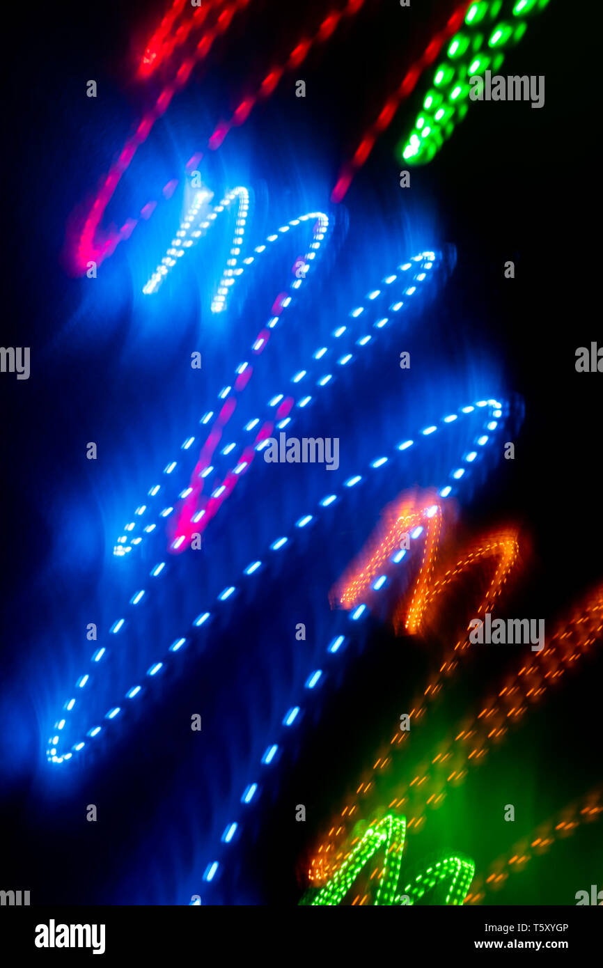 Multicolored glowing zigzag smooth lines on black background.  Stock Photo