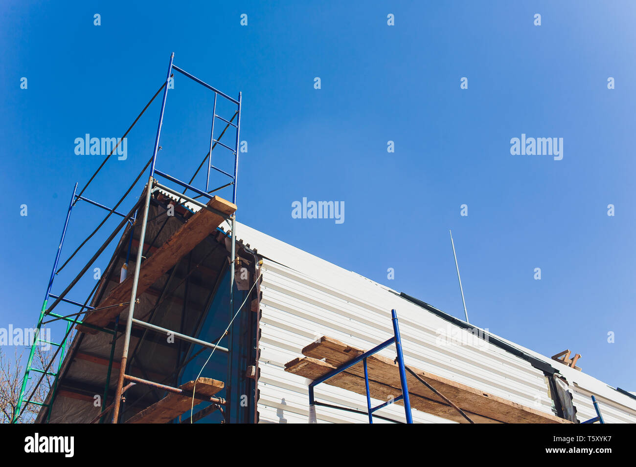 Scaffold between floors and interior partitions in construction building aerial view. Employees