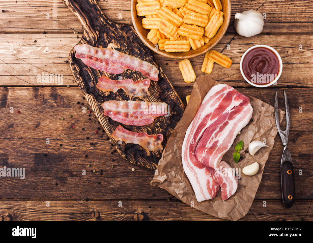 Bacon flavored snacks chips with grilled bacon rashers on vintage