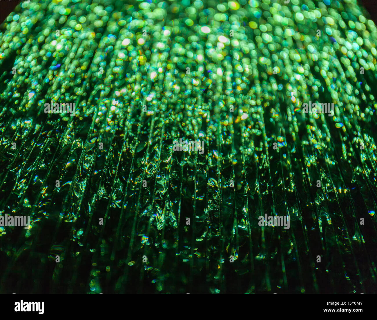 Light passing through a stack of green glass. Abstract background, bokeh Stock Photo