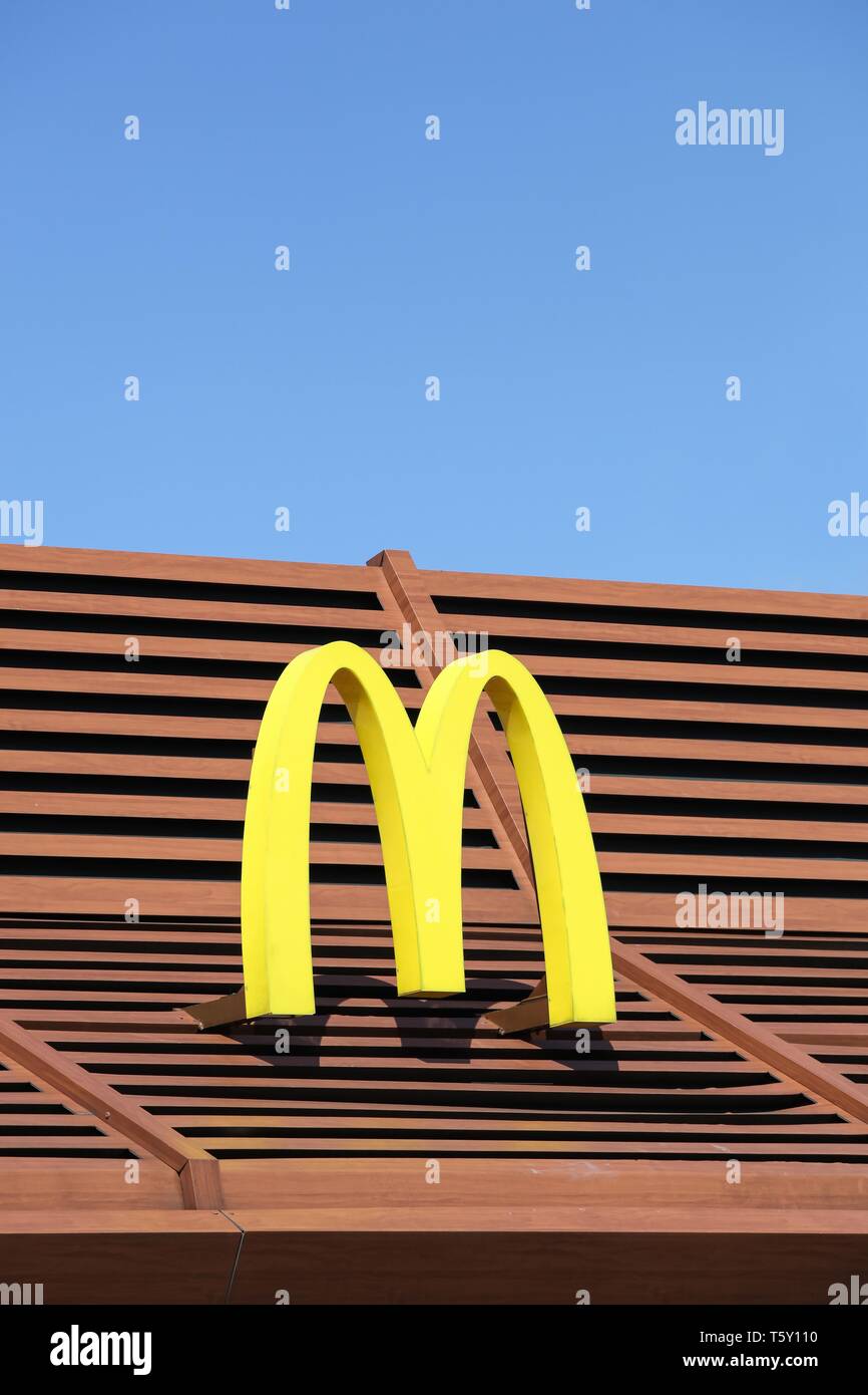 Vejle, Denmark - April 21, 2018: Mc Donald's logo on a facade. McDonald's is the world's largest chain of hamburger fast food restaurants Stock Photo