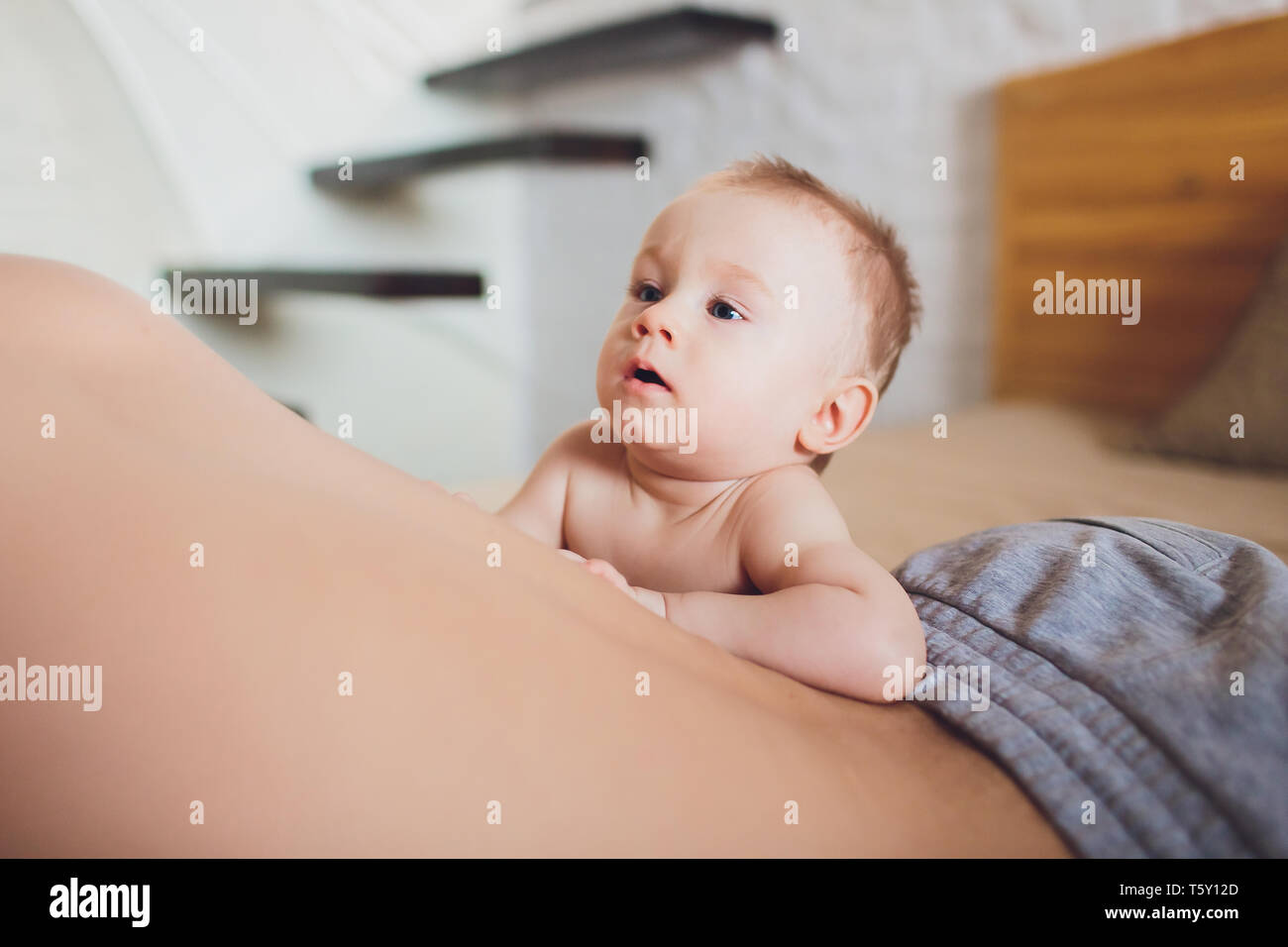 Happy father with baby lying on bed at home Stock Photo - Alamy