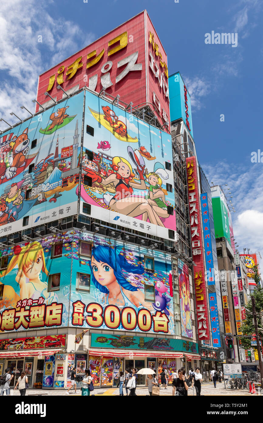 Anime-style billboards and Pachinko E-Space Nittaku sign on building, Shinjuku, Tokyo, Japan Stock Photo