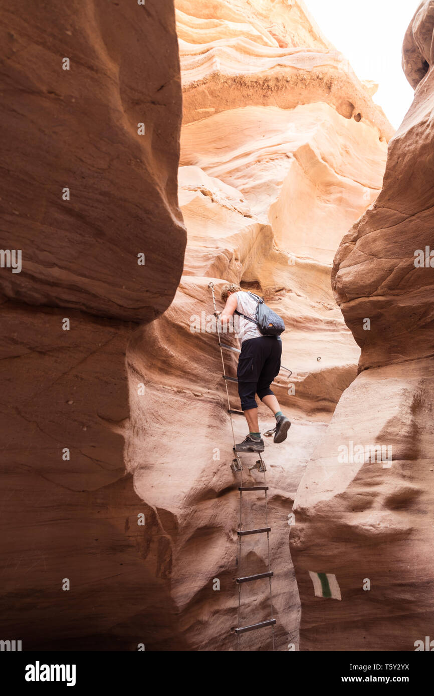 woman climb a ladder in the red canyon of israel near eilat Stock Photo
