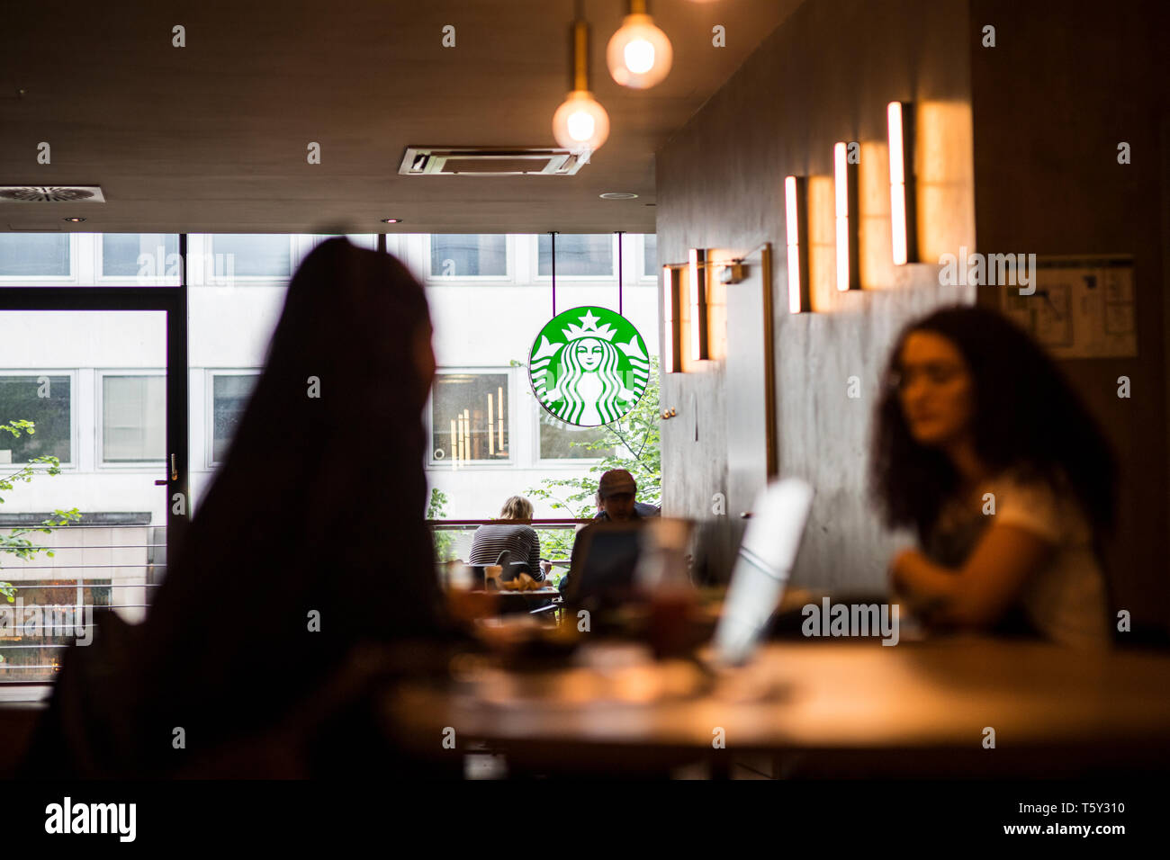 Teenager im Starbucks in Düsseldorf nahe der Königsallee. Mit MR. Stock Photo