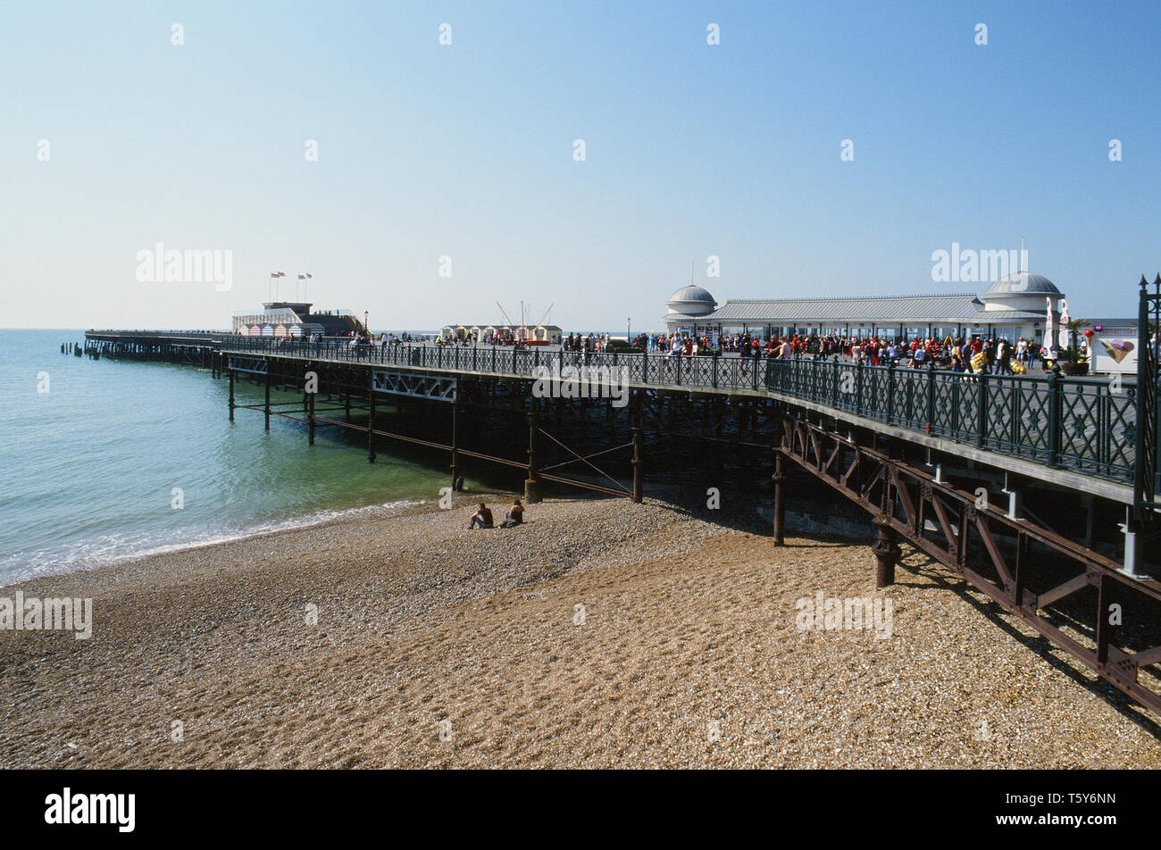 Hastings Pier on a sunny weekend, East Sussex UK, with crowds on the pier Stock Photo