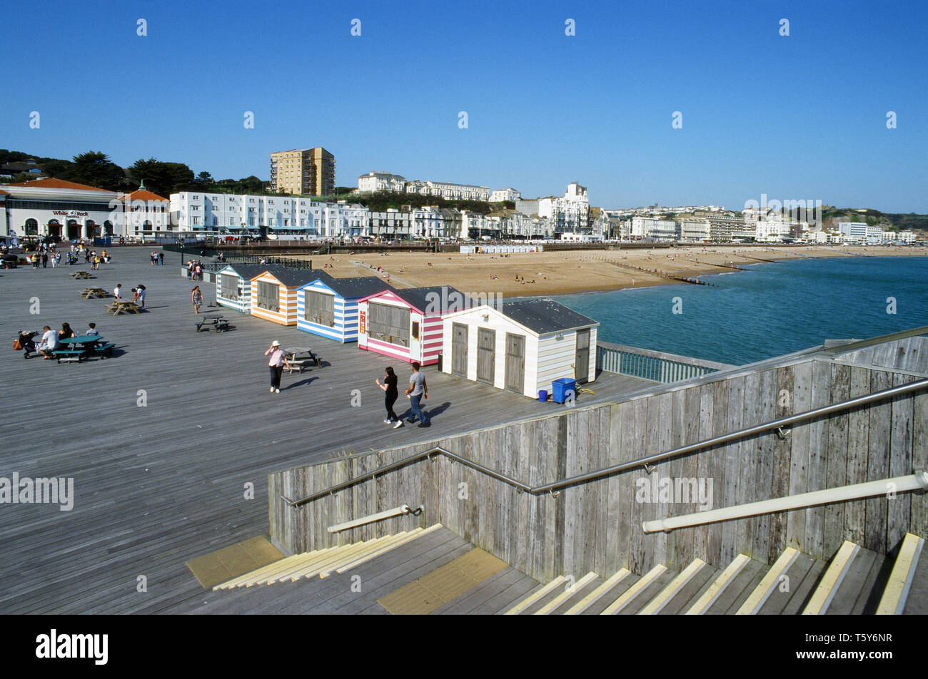 Hastings Pier, East Sussex UK, with pedestrians, looking towards Hastings seafront Stock Photo