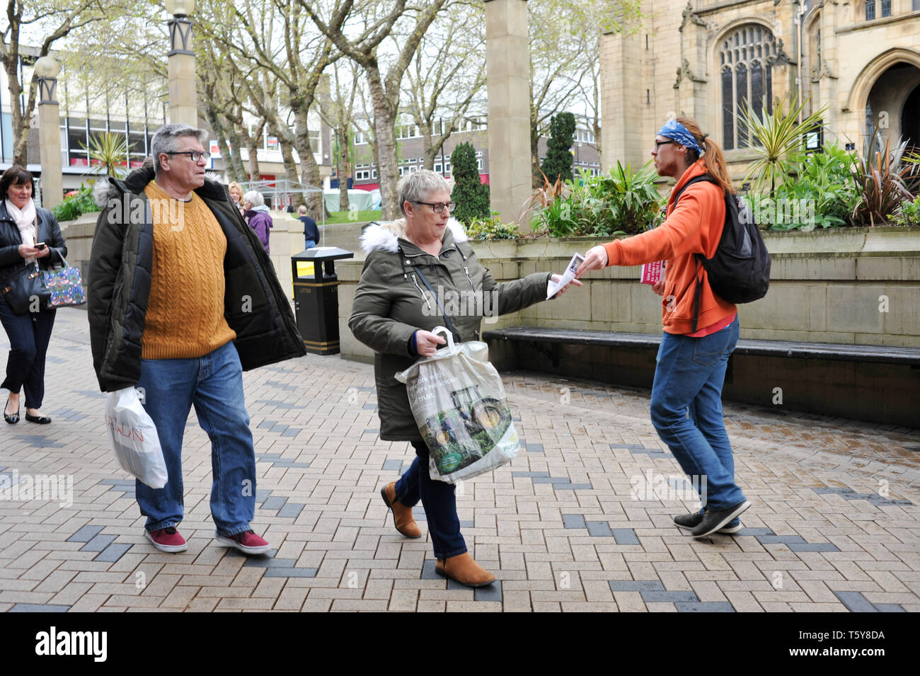 An anti-UKIP protestor giving leaflets to passing shoppers in the city centre ahead of local elections, Wakefield, West Yorkshire, England, UK, 27th April 2019. Stock Photo