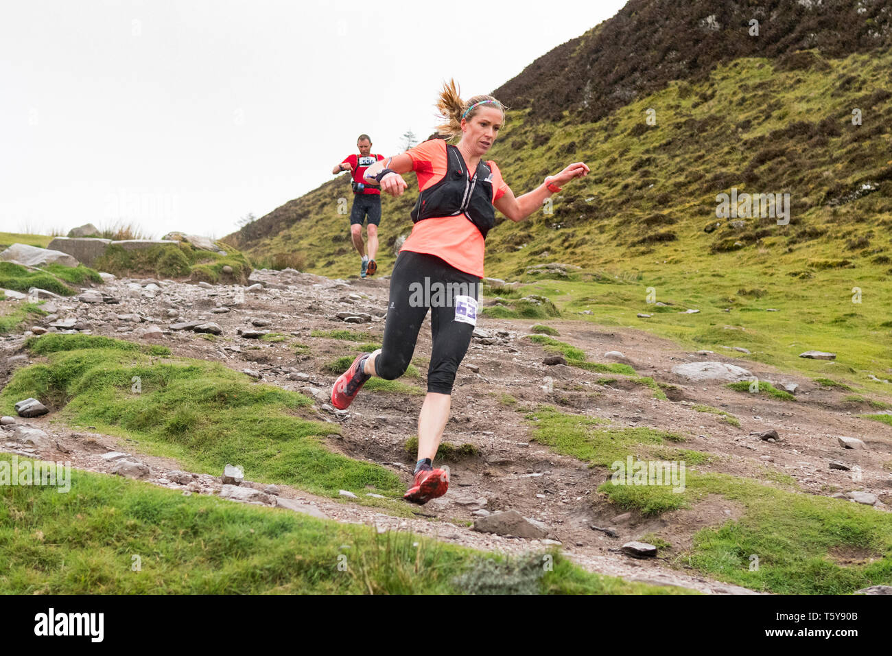 Conic Hill, Loch Lomond, Scotland, UK - 27 April 2019: uk weather - very heavy showers partially obscure the views over Loch Lomond for ultra marathon runners decending Conic Hill in the early stages of the 53 mile Highland Fling Race.   The arduous ultra marathon trail race follows the path of the West Highland Way through Loch Lomond and the Trossachs National Park between Milngavie and Tyndrum.  Pictured is Beth Pascall, the female winner Credit: Kay Roxby/Alamy Live News Stock Photo