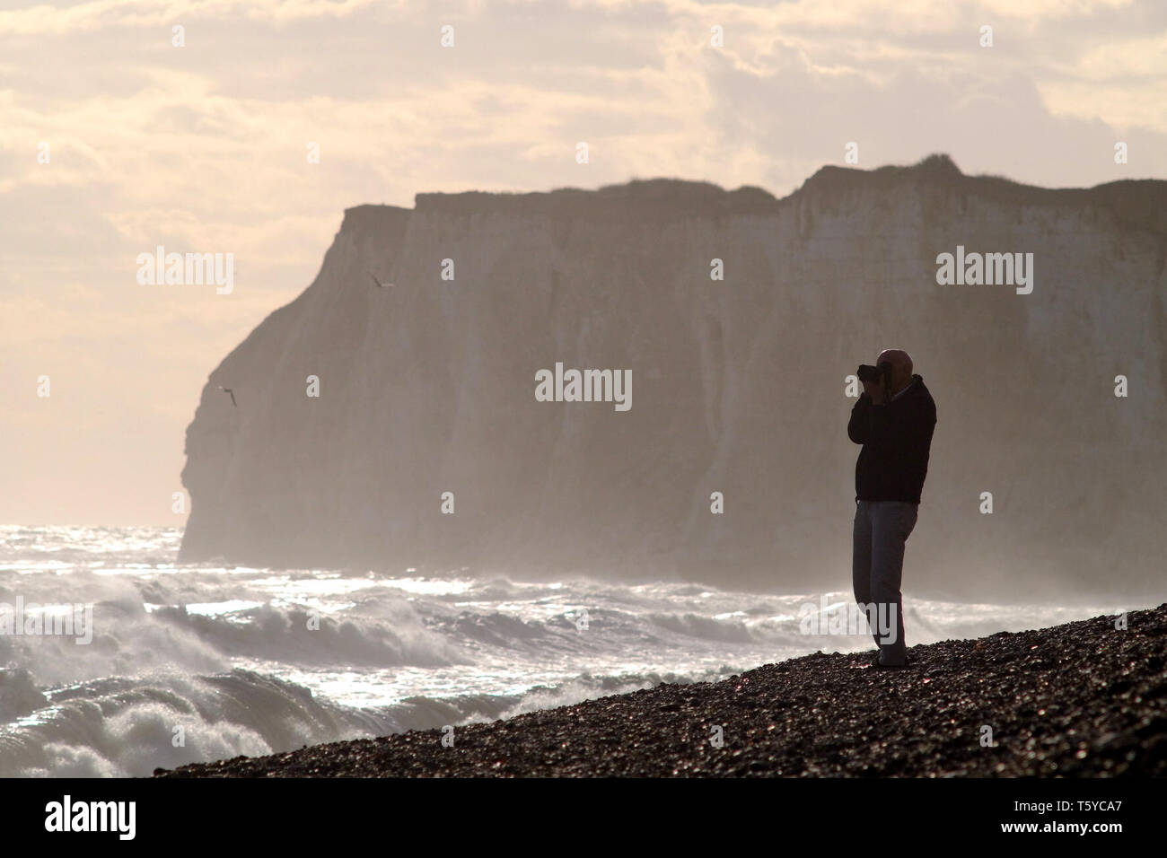 Photographer on a stormy beach Stock Photo