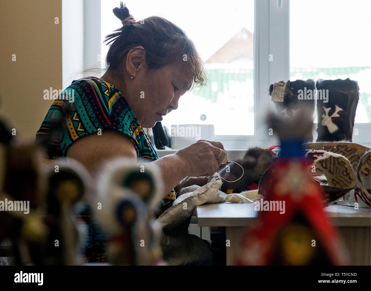 Russia. 27th Apr, 2019. NENETS AUTONOMOUS AREA, RUSSIA - APRIL 27, 2019: Craftswoman Anisia Tabarei at work at the Temboiko house of arts and crafts in the village of Krasnoye, Zapolyarny District. The name 'temboiko' in the Nenets language means a string or a thread connecting generations and passing on traditions. Sergei Malgavko/TASS Credit: ITAR-TASS News Agency/Alamy Live News Stock Photo