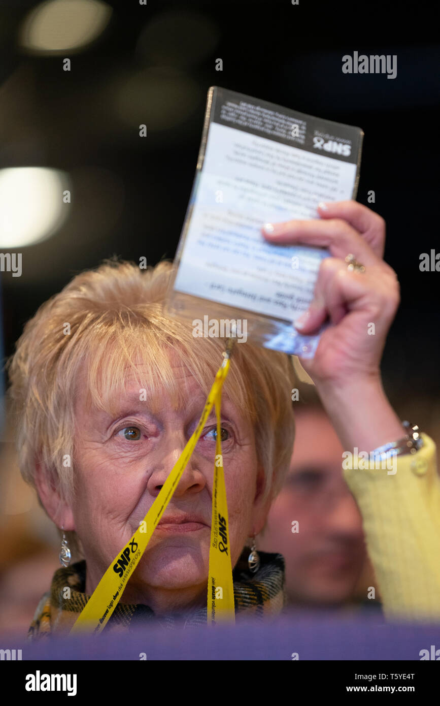 Edinburgh, Scotland, UK. 27 April, 2019. SNP ( Scottish National Party) Spring Conference takes place at the EICC ( Edinburgh International Conference Centre) in Edinburgh. Pictured; Female delegate voting during a session on day 1. Credit: Iain Masterton/Alamy Live News Stock Photo