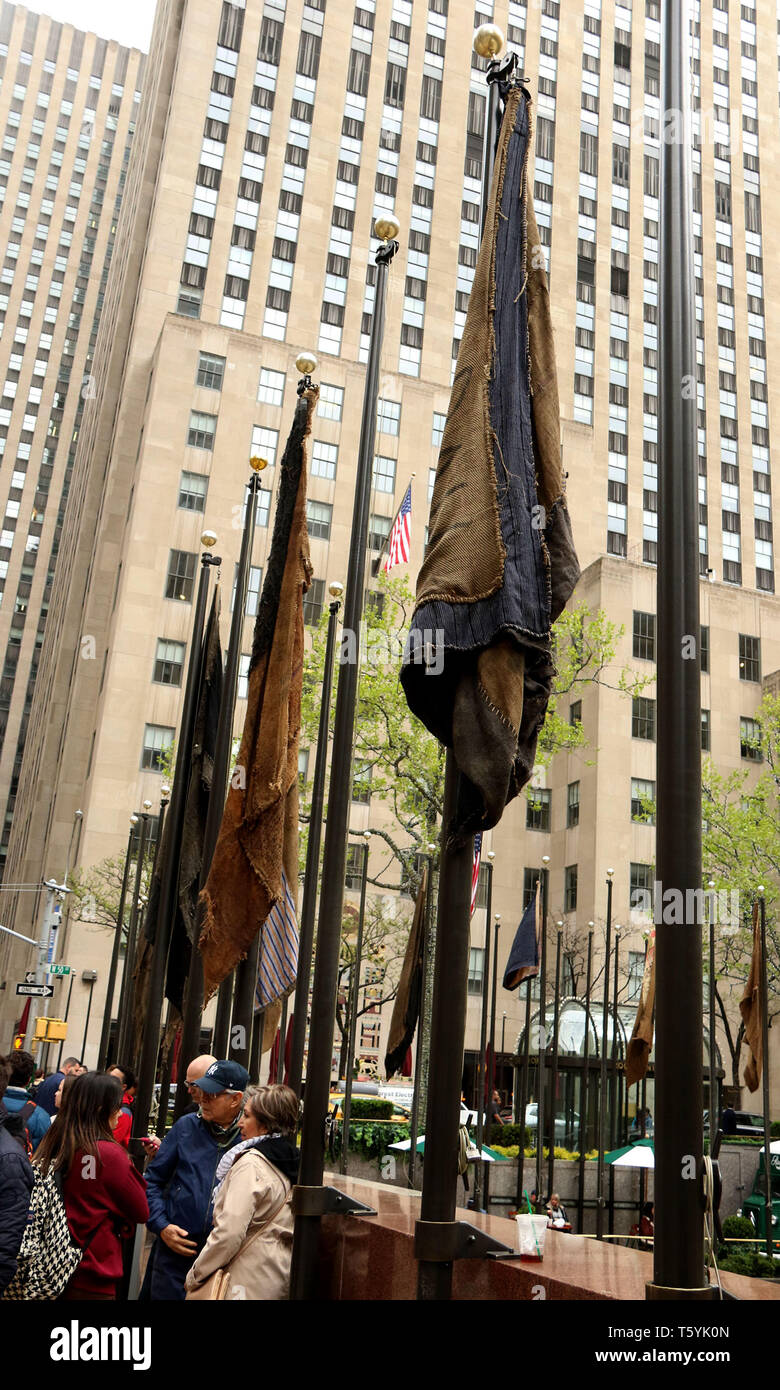 New York City, New York, USA. 27th Apr, 2019. United Nations flags remade using jute sackcloth by art IBRAHIM MAHAMA on display at the Frieze Sculpture exhibit held at Rockefeller Center. Credit: Nancy Kaszerman/ZUMA Wire/Alamy Live News Stock Photo