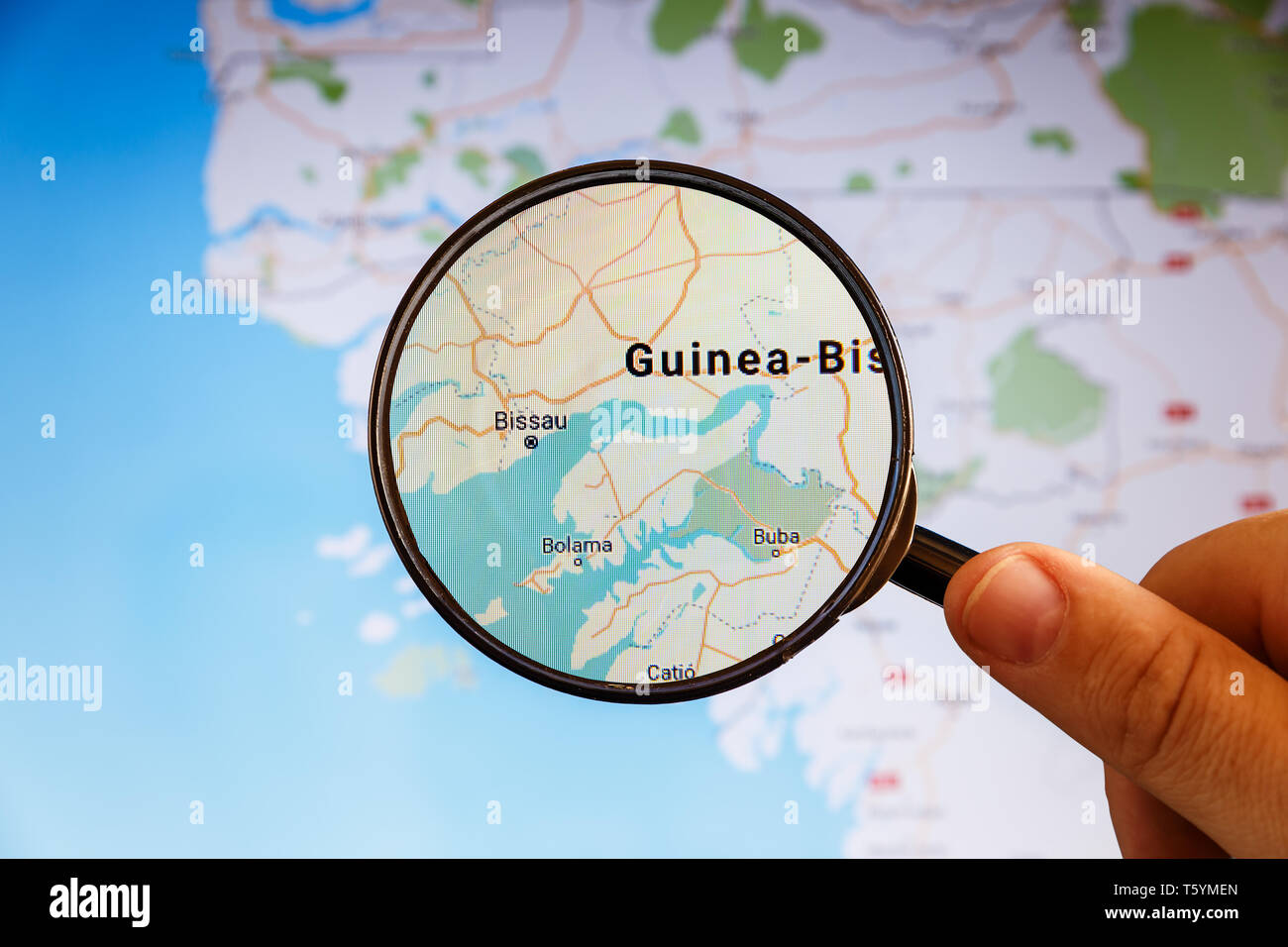 Bissau, Guinea-Bissau. Political map. City visualization illustrative concept on display screen through magnifying glass in the hand. Stock Photo
