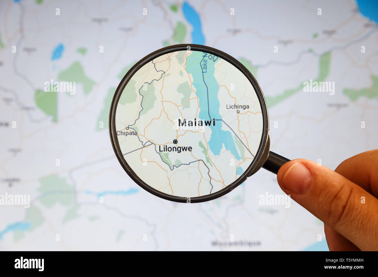 Lilongwe, Malawi. Political map. City visualization illustrative concept on display screen through magnifying glass in the hand. Stock Photo