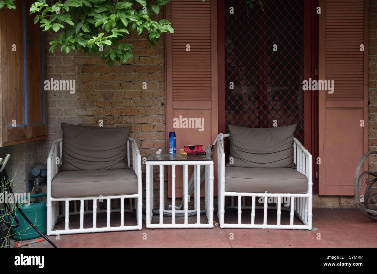 garden chairs and table on front porch, newtown, sydney, australia