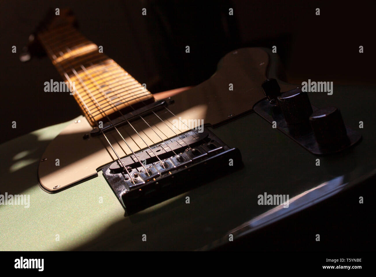 Electric guitar in creative lighting with shadows, closeup image Stock Photo