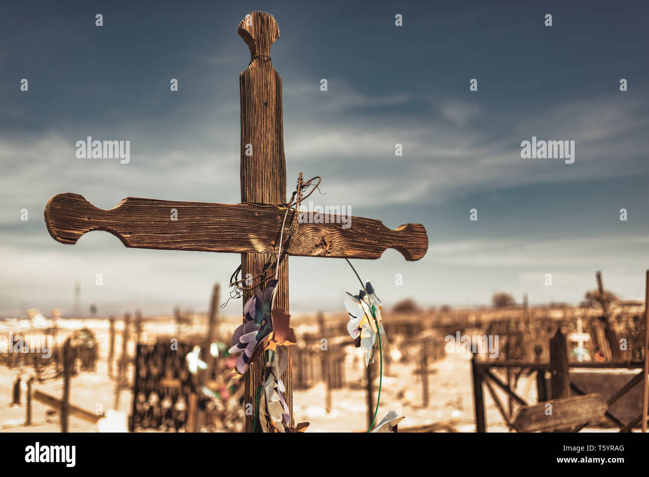 Wooden Cross in Abandoned Cemetery in the Atacama Desert, Northern Chile. From the era of nitrate mining  - Selective Focus Stock Photo