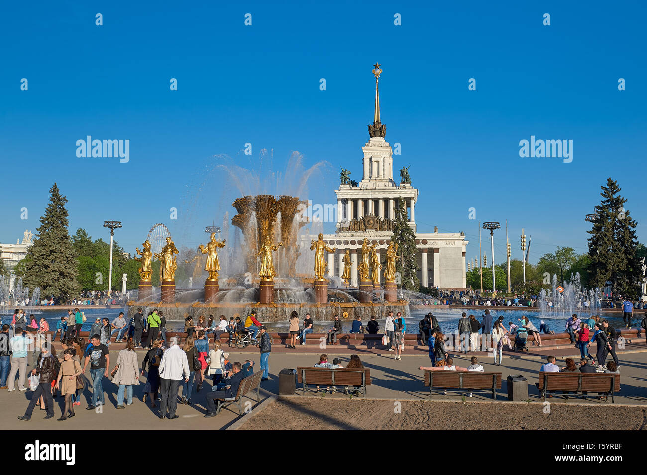 Moscow, Russia - May 9, 2014: People are resting near the fountain Friendship of Peoples on the All-Russian Exhibition Center (VDNH) Stock Photo