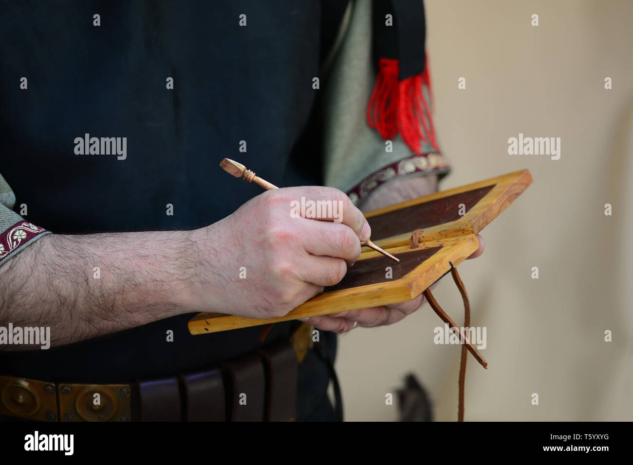 Roman empire soldier writing on wax tablet detail Stock Photo