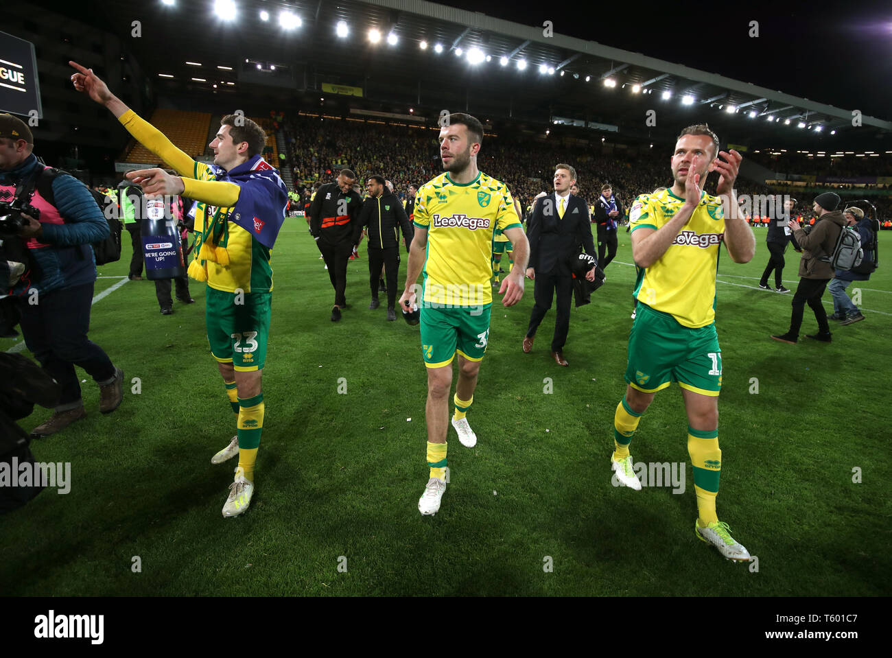 Norwich City's Kenny McLean, Norwich City's Grant Hanley and Norwich City's Jordan Rhodes celebrate promotion to the Premier League after the final whistle of the Sky Bet Championship match at Carrow Road, Norwich. Stock Photo