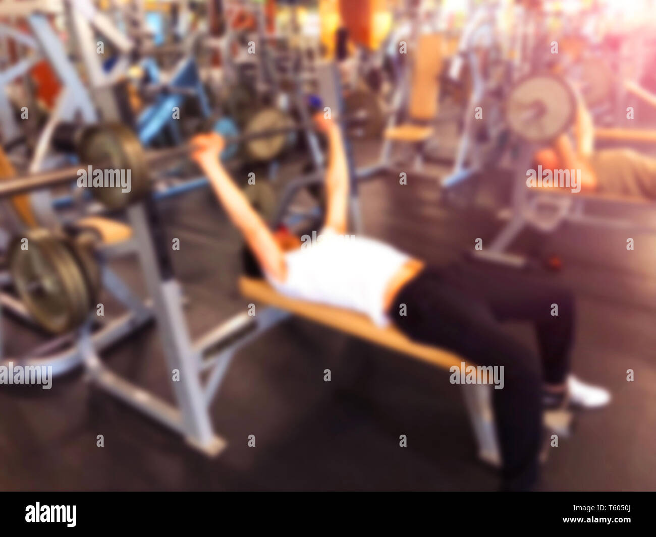 Blurred Background With Man Lifting Barbell Row At Gym Blur