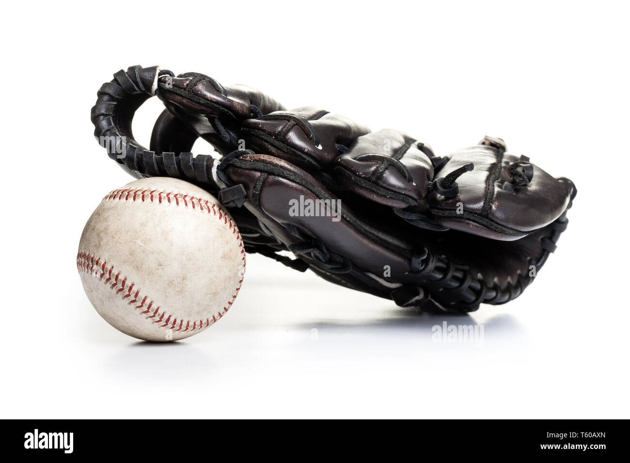 chocolate brown baseball glove with the old ball isolated over white
