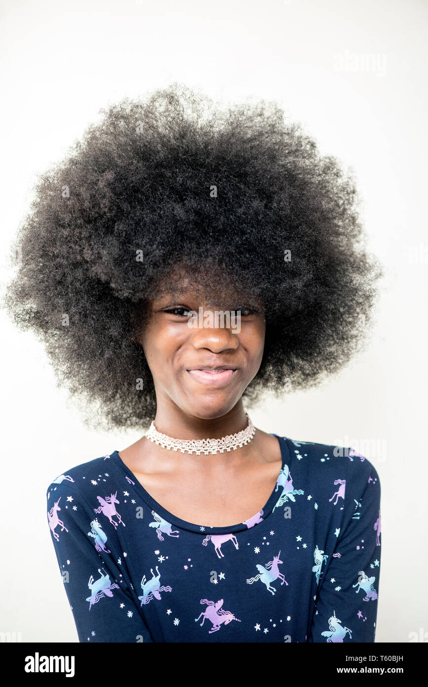 Beautiful Happy Nigerian girl with natural afro and in a blue attire