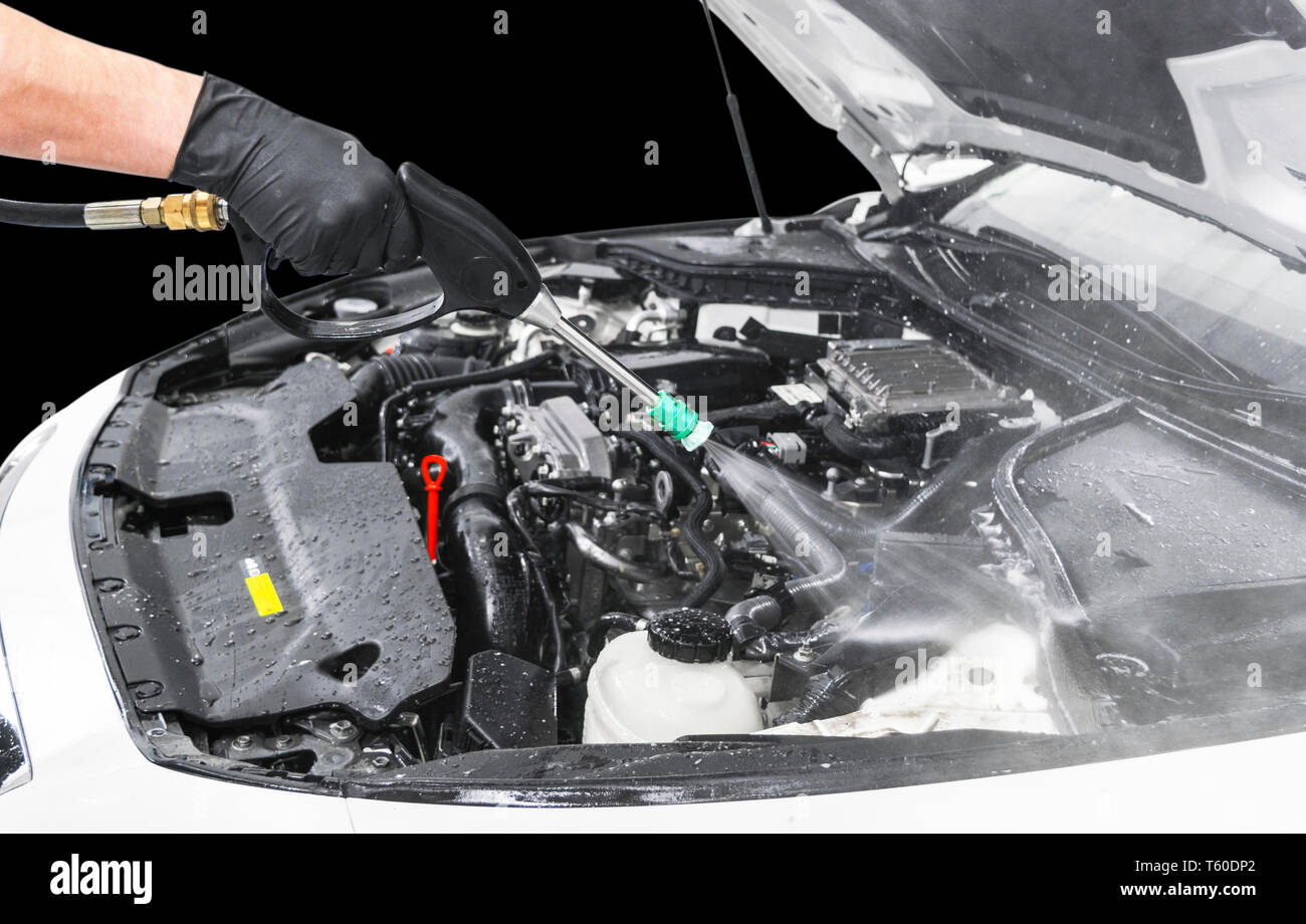 Car detailing. Manual car wash engine with pressure water. Washing car engine with water nozzle
