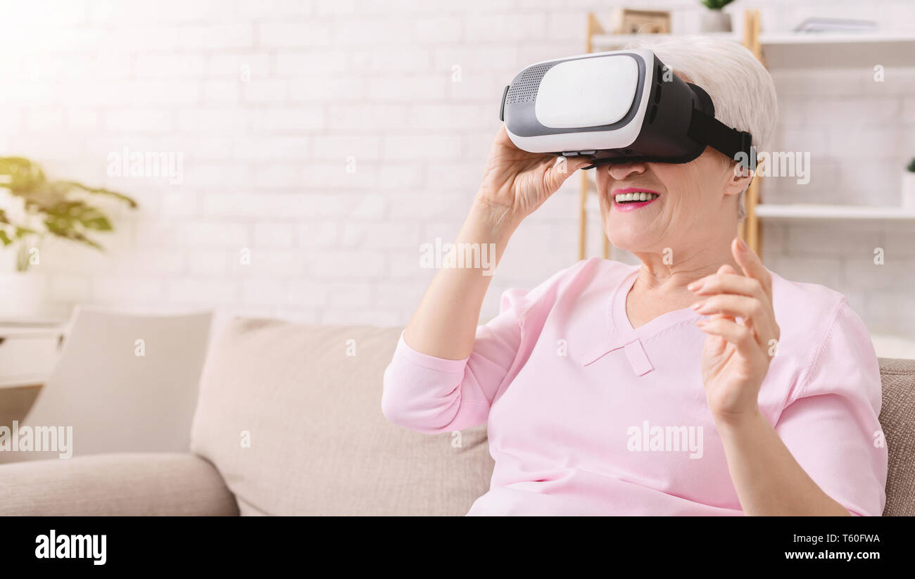 Senior woman wearing virtual reality goggles at home Stock Photo - Alamy