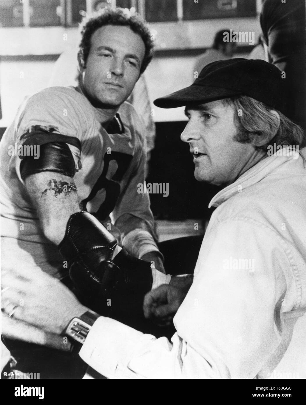 James Caan as Jonathan E. and director Norman Jewison ROLLERBALL 1975 on set candid filming on location Munich Germany  Algonquin / United Artists Stock Photo