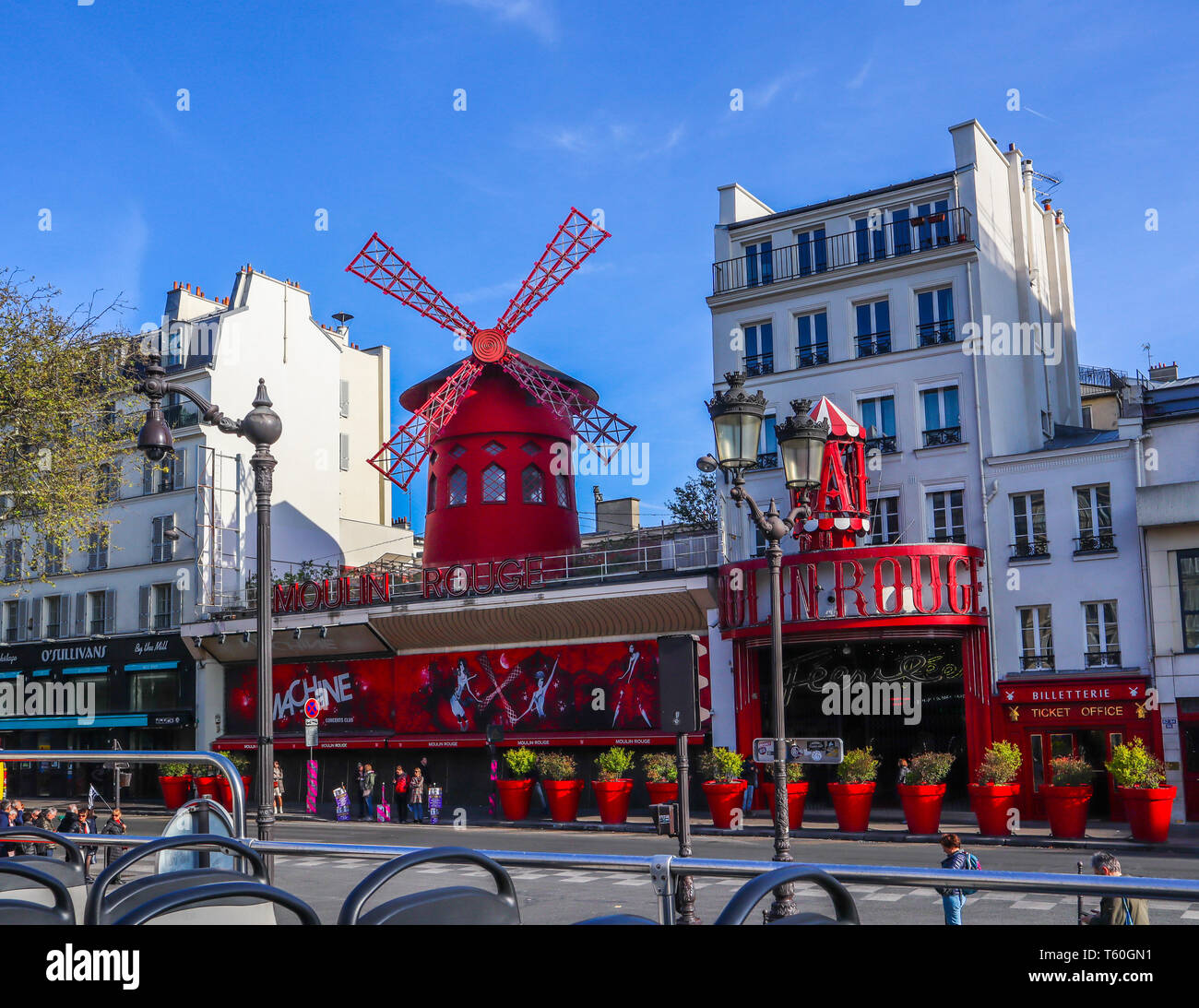 Paris / France - April 06 2019: Moulin Rouge is a famous cabaret in Paris France. View from the tourist bus Stock Photo
