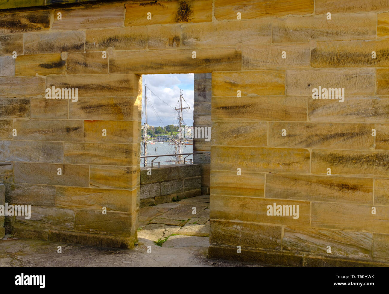 Cockatoo island Sydney, Australia, Historical stone prison building built by convicts for solitary confinement of prisoners, tall sailing ships masts  Stock Photo