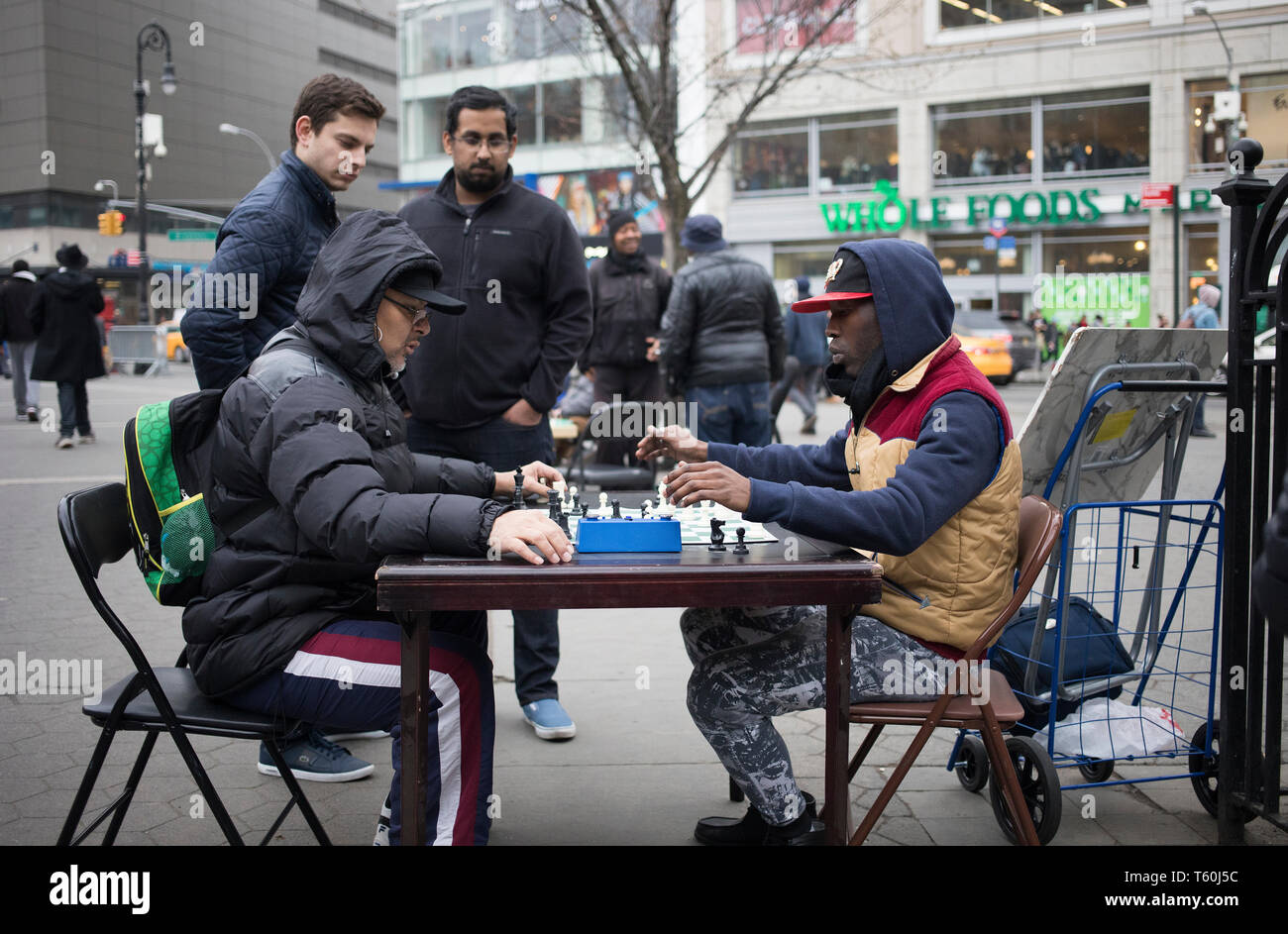 Union Square Park, NY - March 07, 2017: Unidentified afro American people playing chess in the Union Square Park in Manhattan, NY Stock Photo
