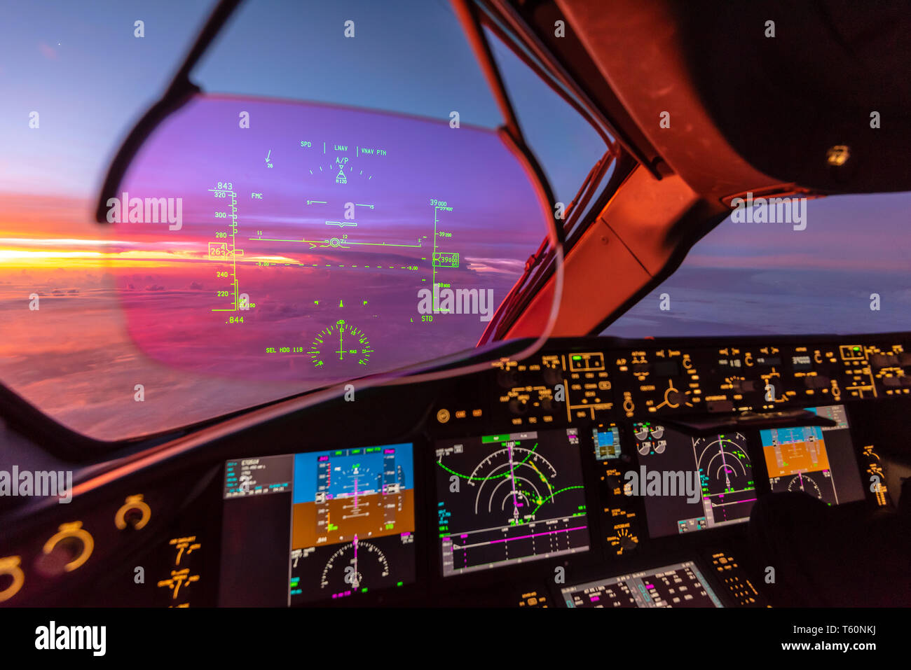 Modern commercial aircraft cockpit with Heads Up Display at sunrise Stock Photo