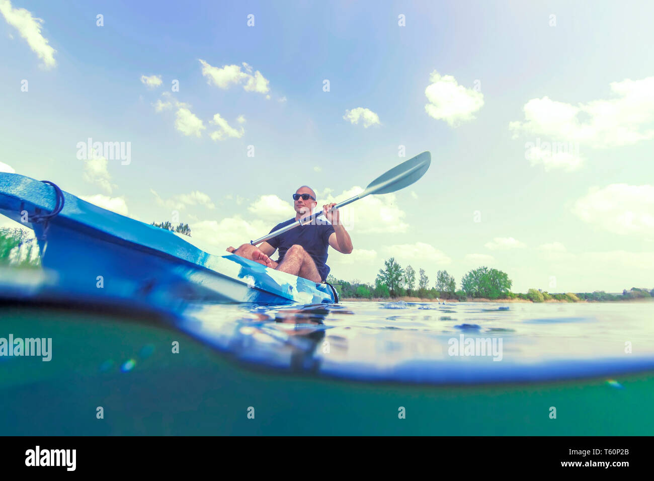Young Man Kayaking on Lake, Kayaking Underwater View, Split Shot Stock