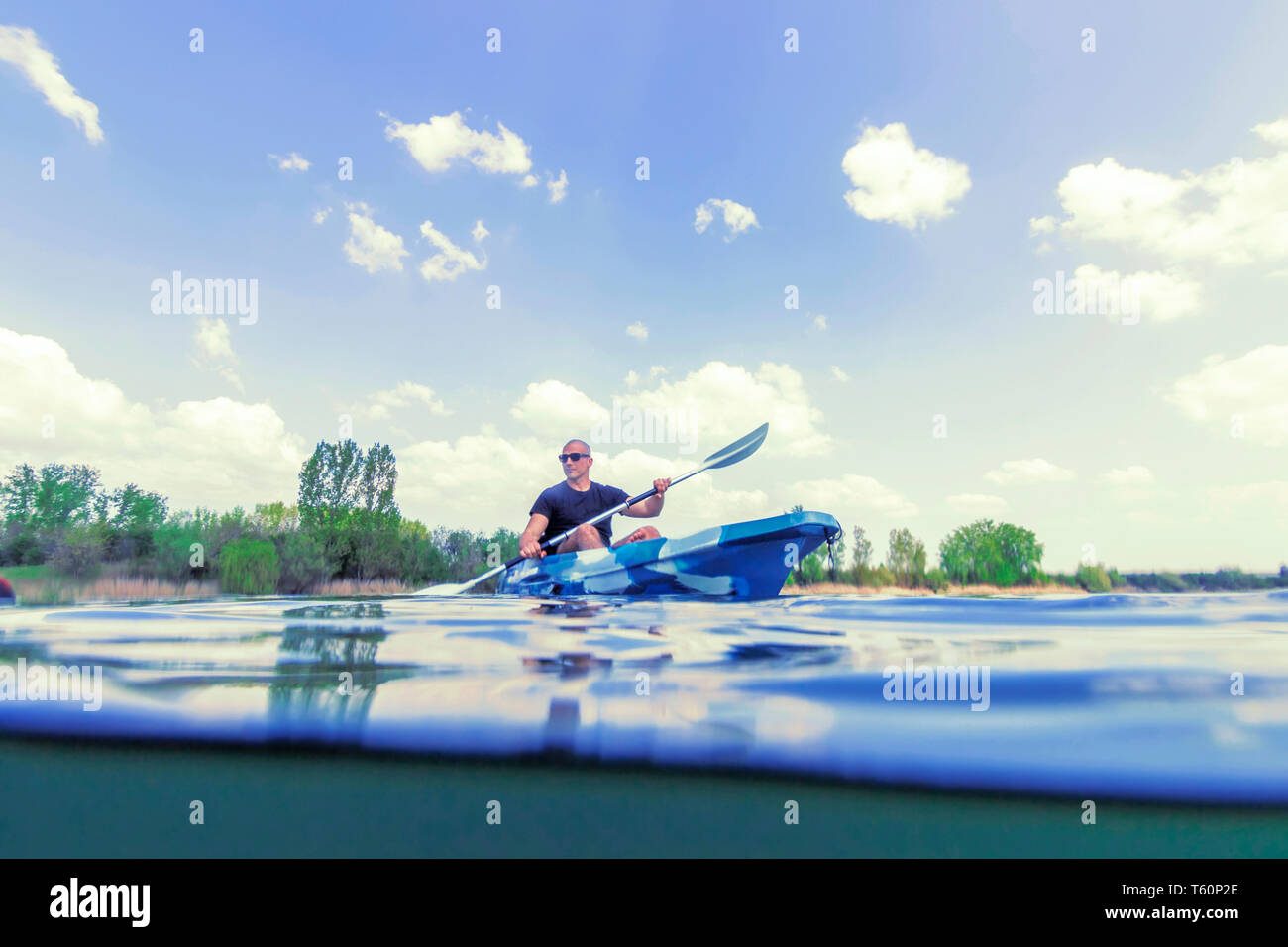 Young Man Kayaking on Lake, Kayaking Underwater View, Split Shot Stock