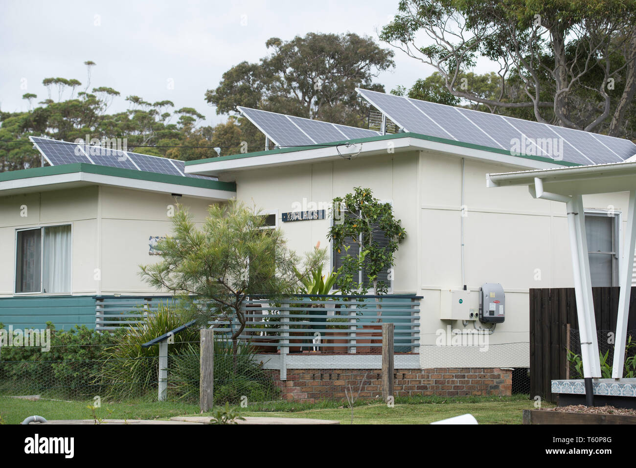 A renovated 1950's fibro (Asbestos fibrous cement) home with solar panels on its roof in the NSW south coast village of Kioloa Stock Photo