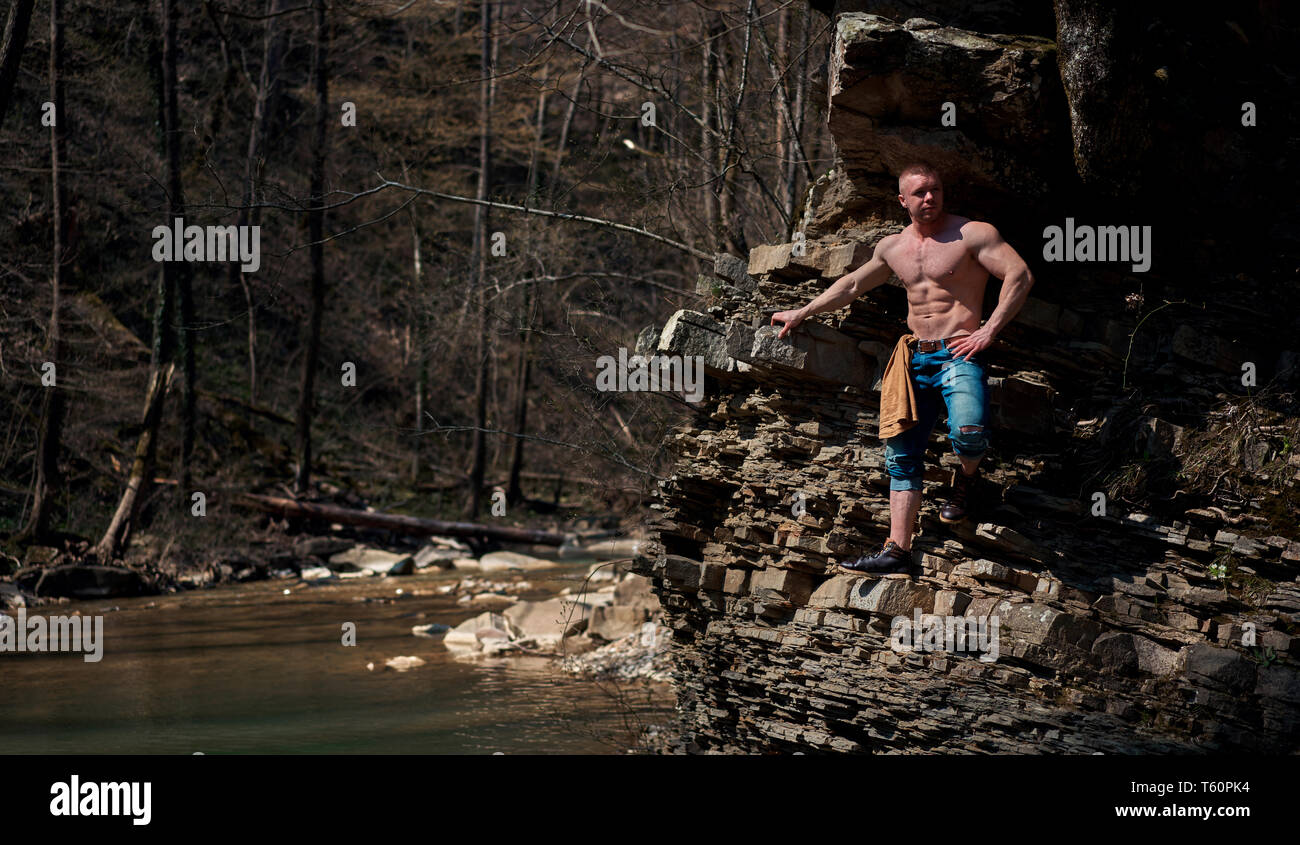 strong man climbs the mountain Stock Photo