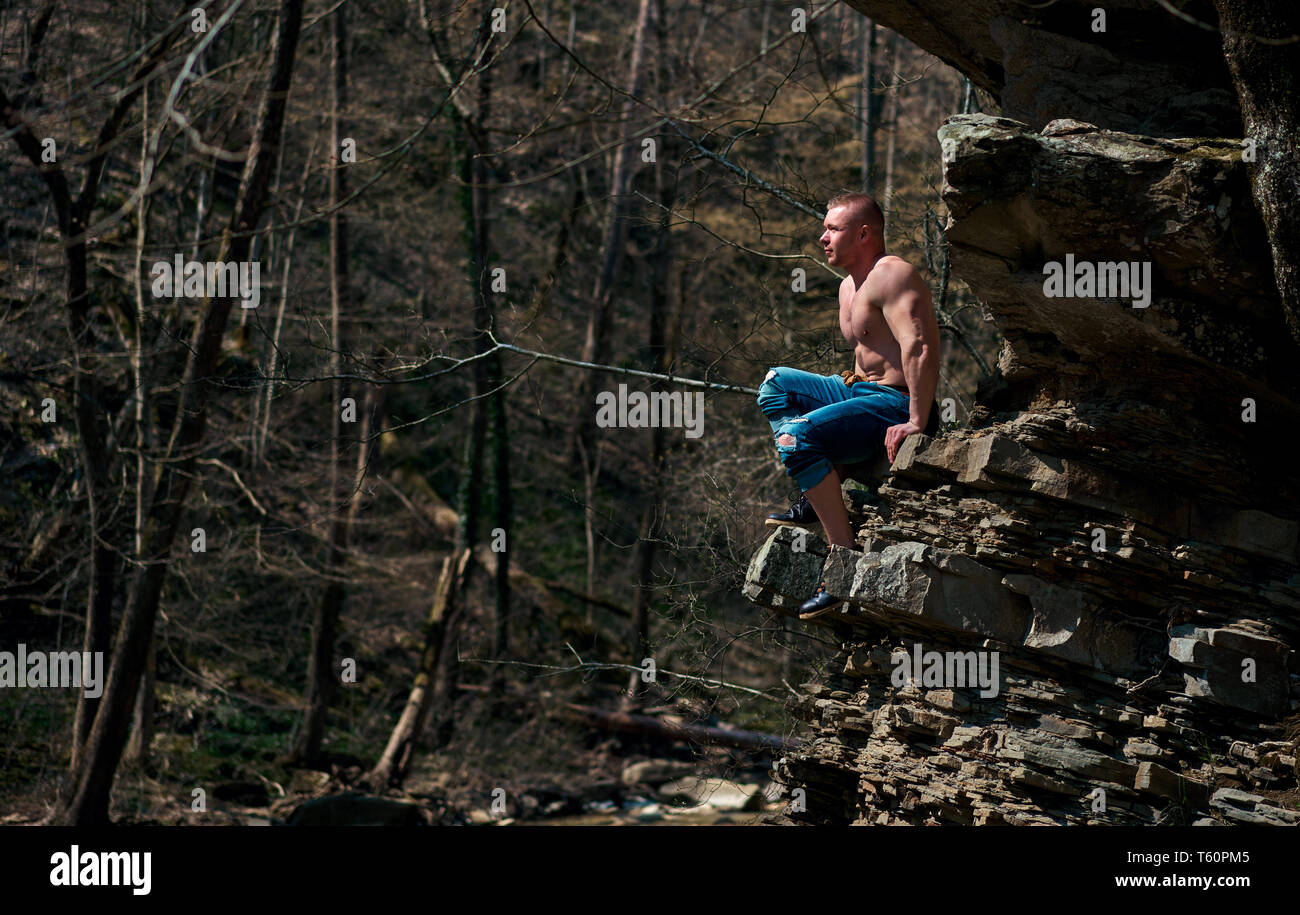 strong man climbs the mountain Stock Photo
