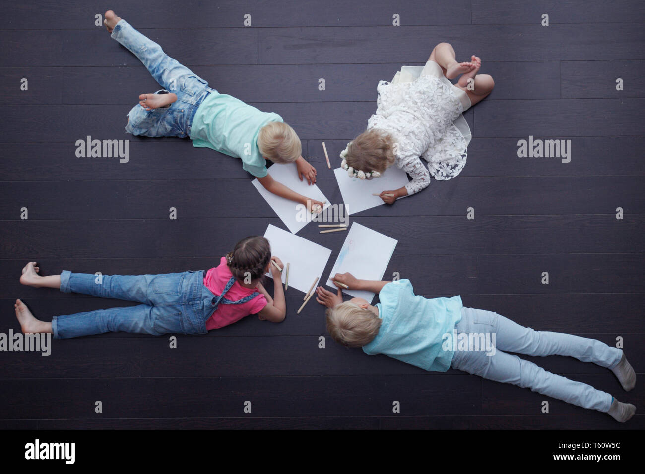 Group of cute children drawing with colorful pencils on floor Stock ...