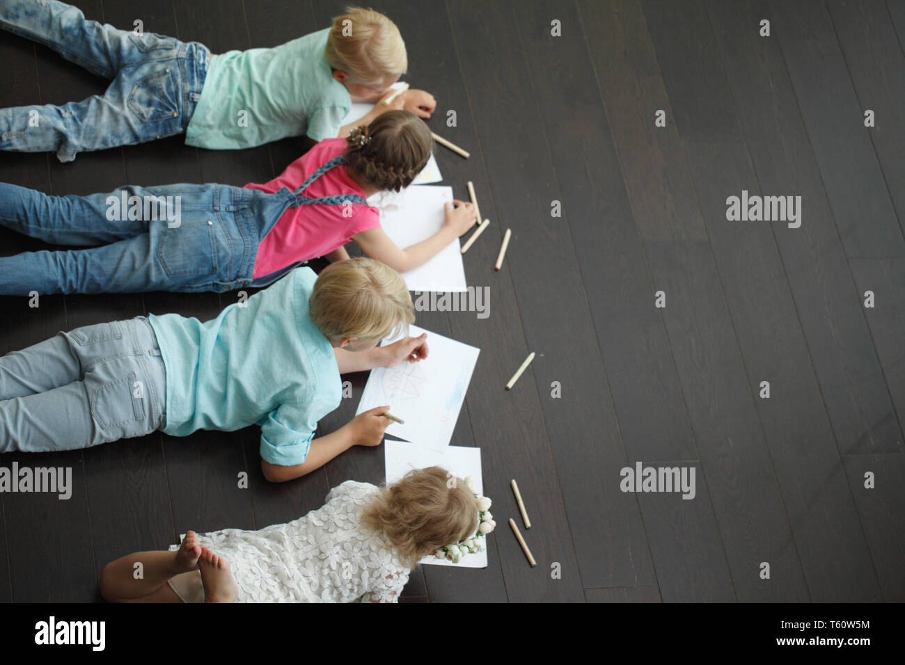Group of cute children drawing with colorful pencils on floor Stock ...