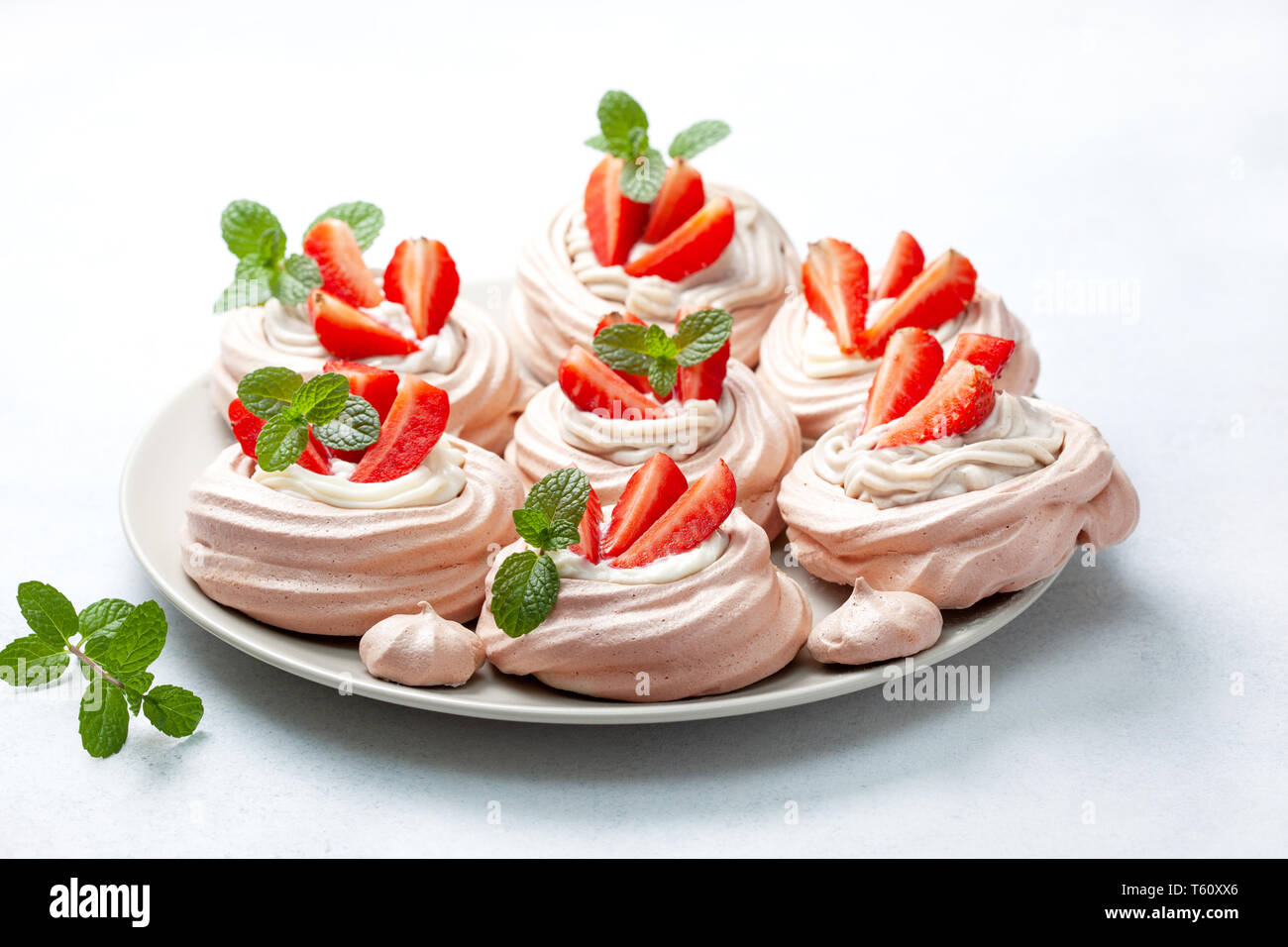 pavlova chocolate mini cakes with strawberries close-up Stock Photo