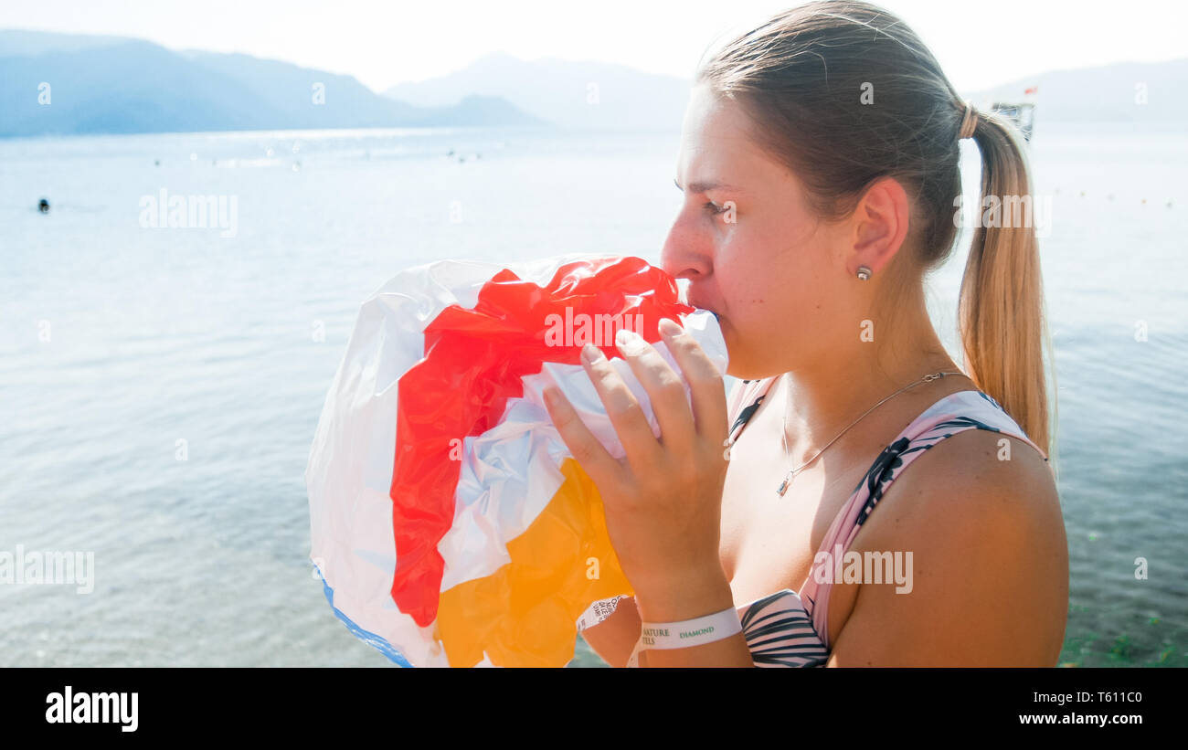 Blowing up inflatable beach ball hi-res stock photography and images ...