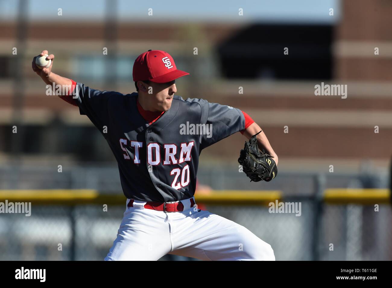 Pitcher delivering a pitch to a waiting opposing hitter. USA. Stock Photo