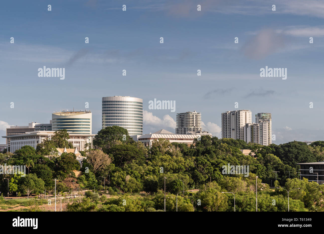 Darwin Australia - February 22, 2019: South side office towers in downtown behind green zone holding Government House bordering harbour under blue sky Stock Photo